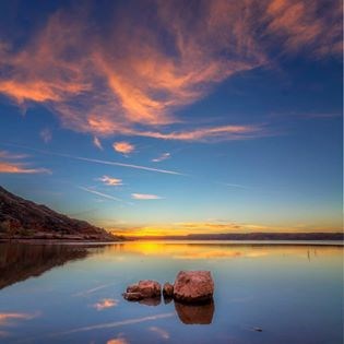 Sunset Harbor Bay with many colors of yellow, blue, orange, and red.