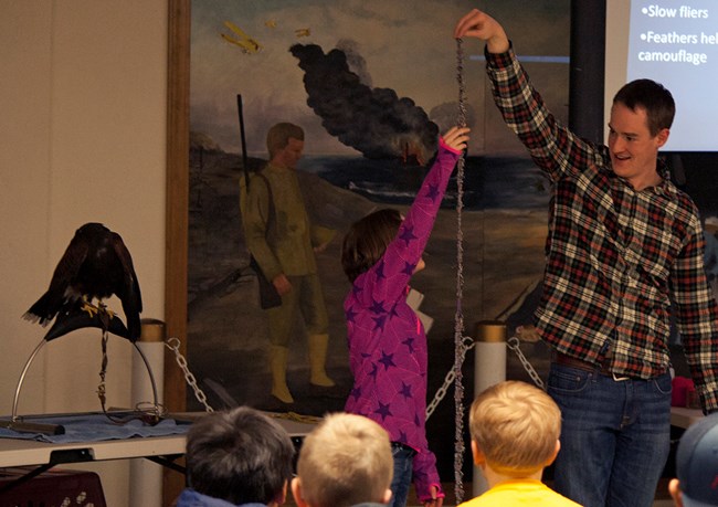 Presenter, student, and hawk at Bird Fest (formerly Balde Eagle Festival)