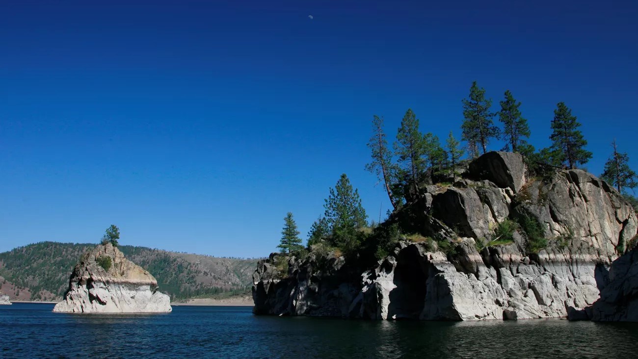 A landscape view of the lake with a rocky shoreline.