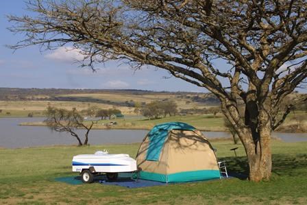 tent and trailer at campsite with Spioenkop Lake in the background