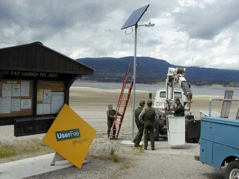 Maintenance installing a solar powered light at a boat dock. Maintenance installing a solar powered light at a boat dock.