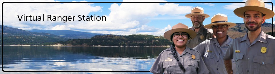 Park Rangers stand near the lake, ready to answer questions.