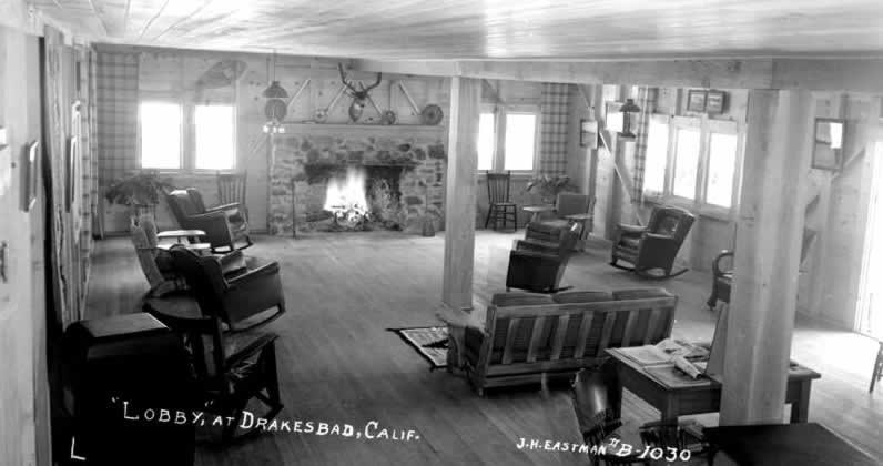 interior of lodge in 1939 with wood floors, fireplace, and rocking chairs