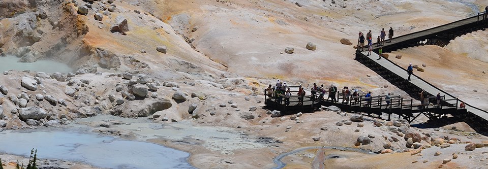 Visitors on a boardwalk in Bumpass Hell hydrothermal area Visitors on a boardwalk in Bumpass Hell hydrothermal area