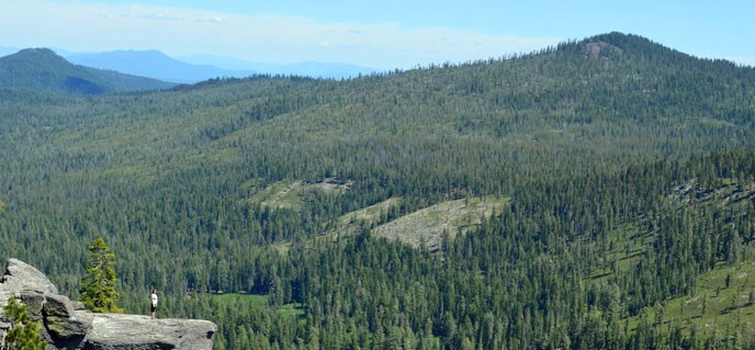 A hiker looks out over Warner Valley from Flatiron Ridge