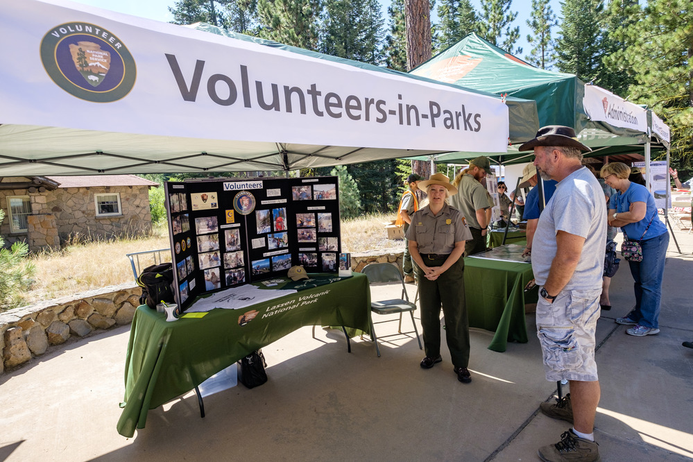 A Lassen Volcanic National Park Service Ranger staffs a Volunteer-in-Parks information booth.