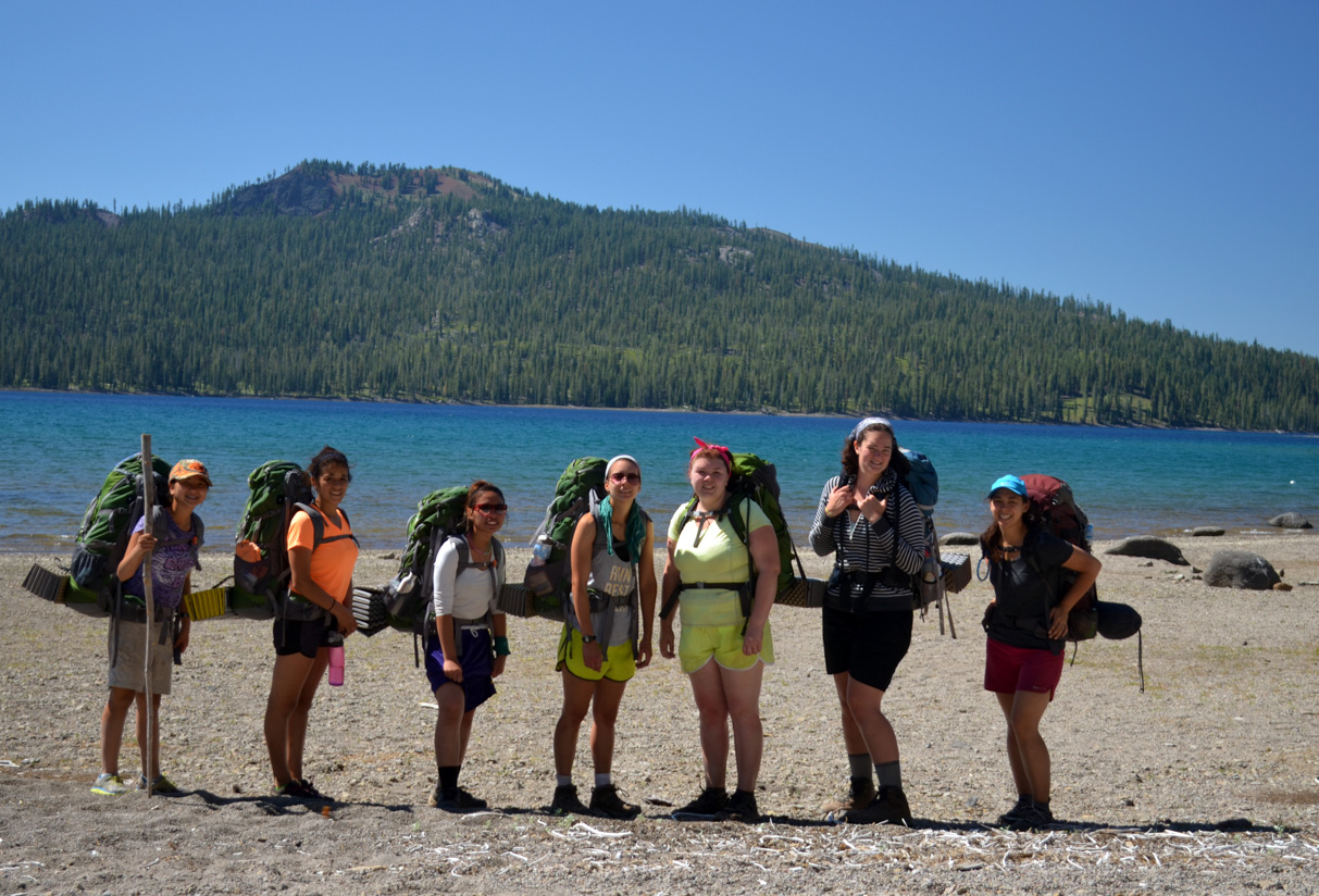 Backpacking hikers looking at the volcano in the background