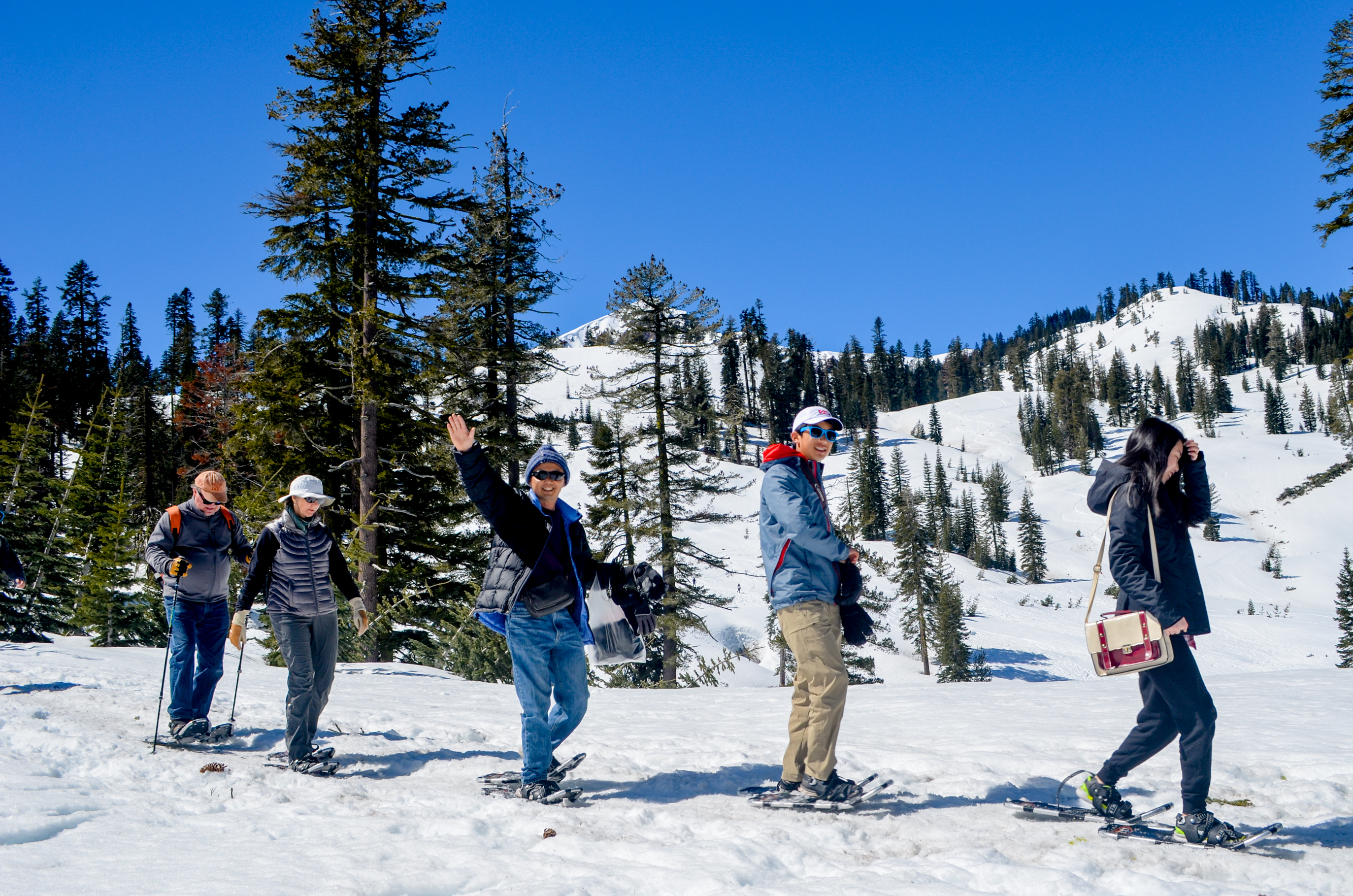 LAVO Ranger-led Snowshoe Walks_ Visitors walking with snowshoes on top of snowy ground