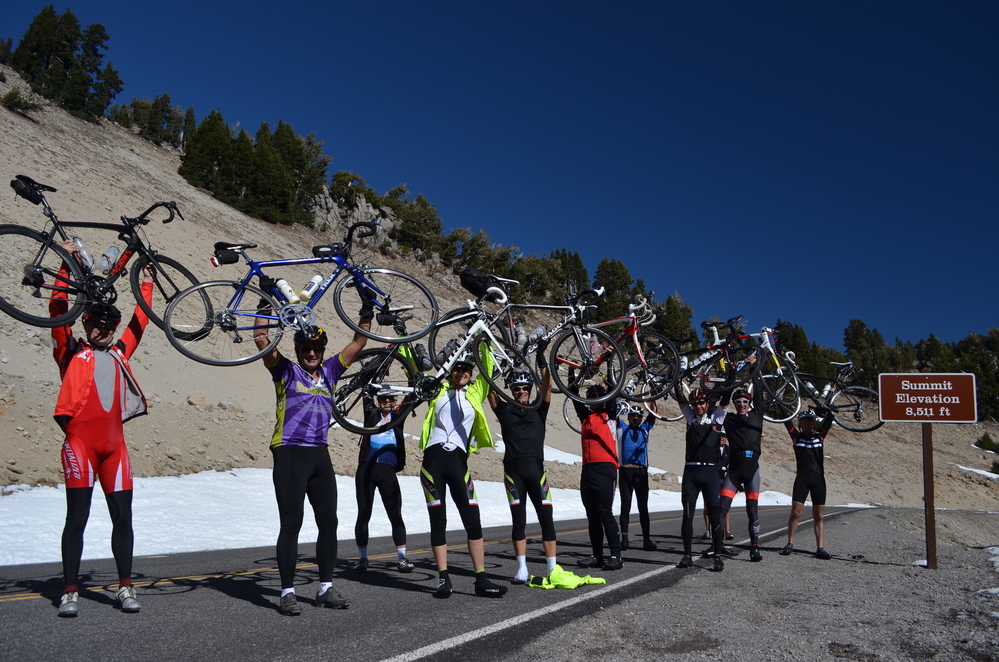 a931898b-9ed8-4f21-902d-507207ee881aHiResProxy A group of bicyclists holding their bikes up on the park road