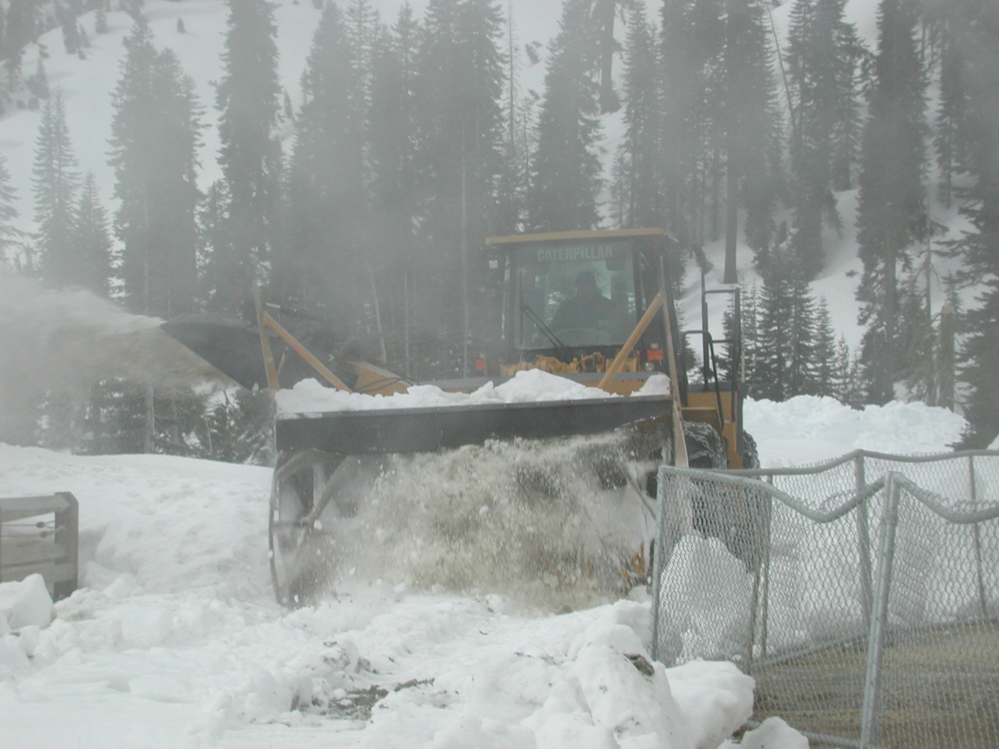 Large rotary snow blower clearing 4 feet of snow.