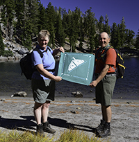 Hikers holding a trail challenge bandana Hikers holding a trail challenge bandana