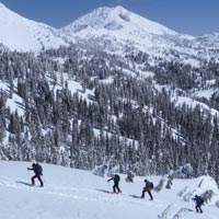 Backcountry skiers enjoy a view of Lassen Peak