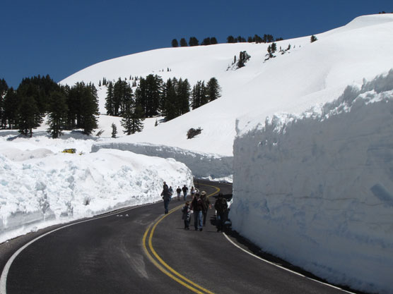 Visitors walk the park road near Lake Helen