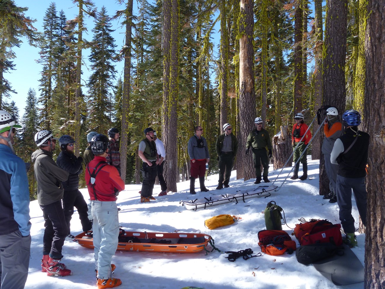 group standing around an orange litter in the snow