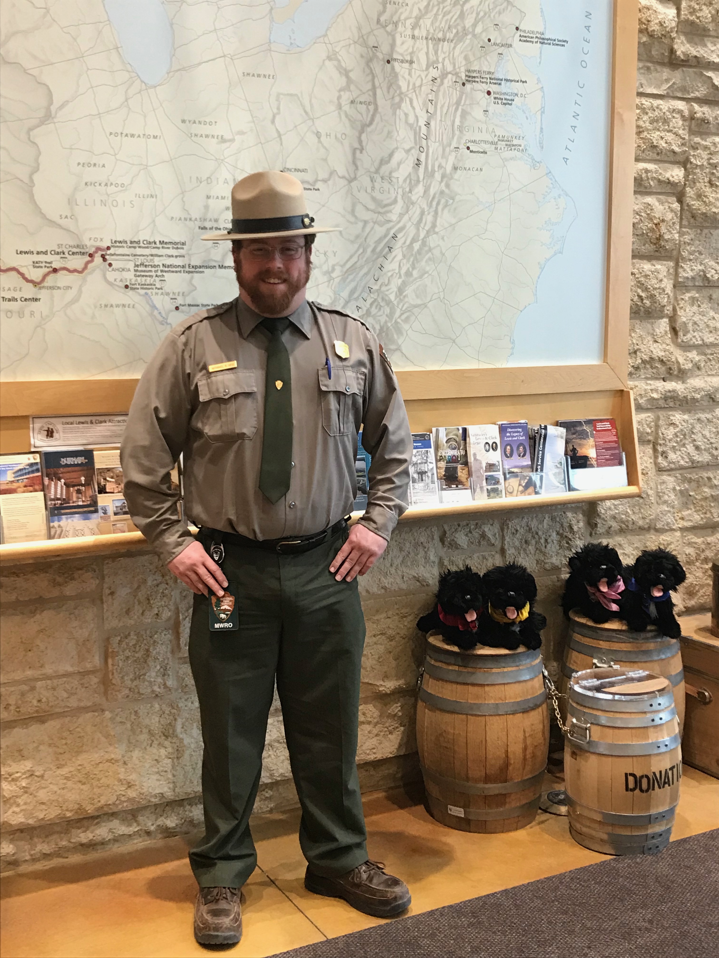 Meet Nate Hess Ranger stands in front of map with pups