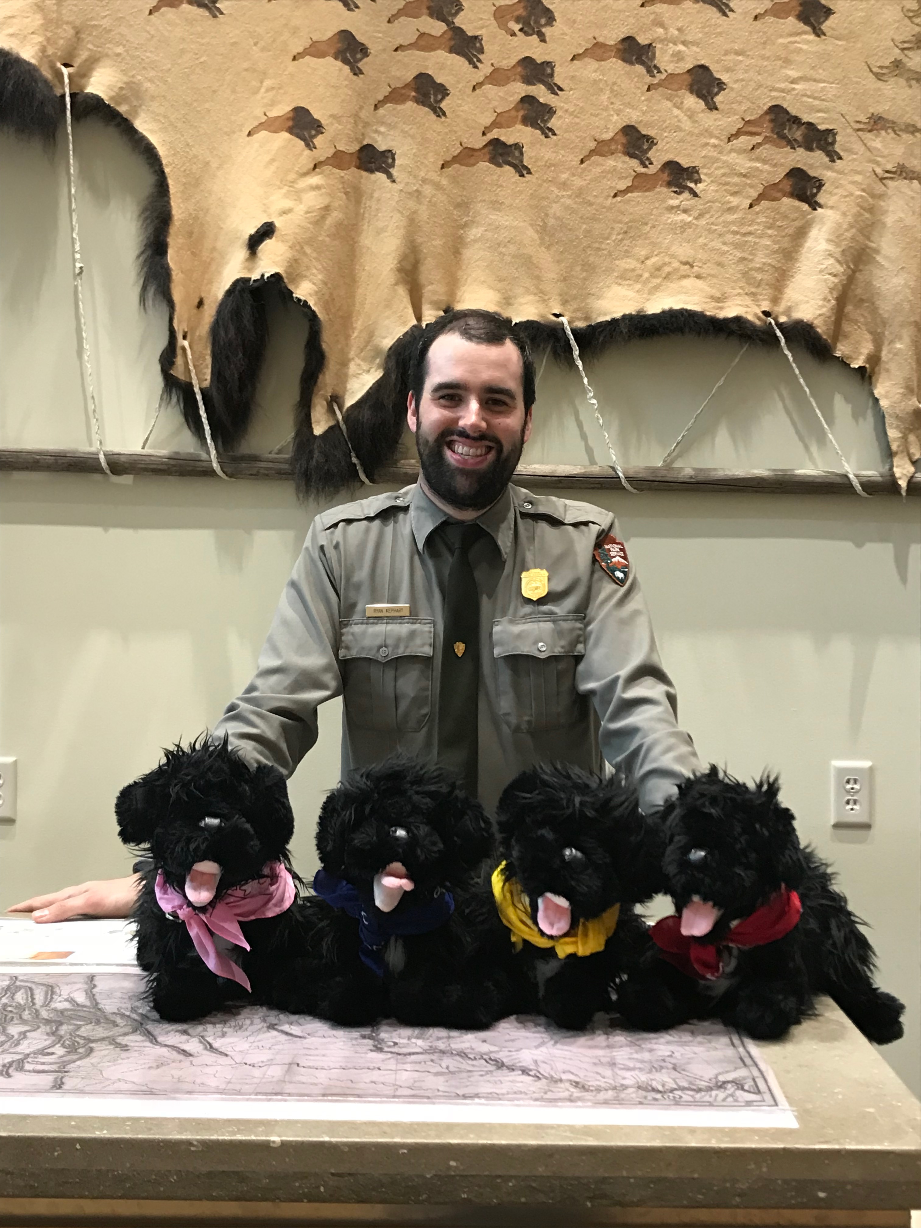 Ranger standing at desk with pups