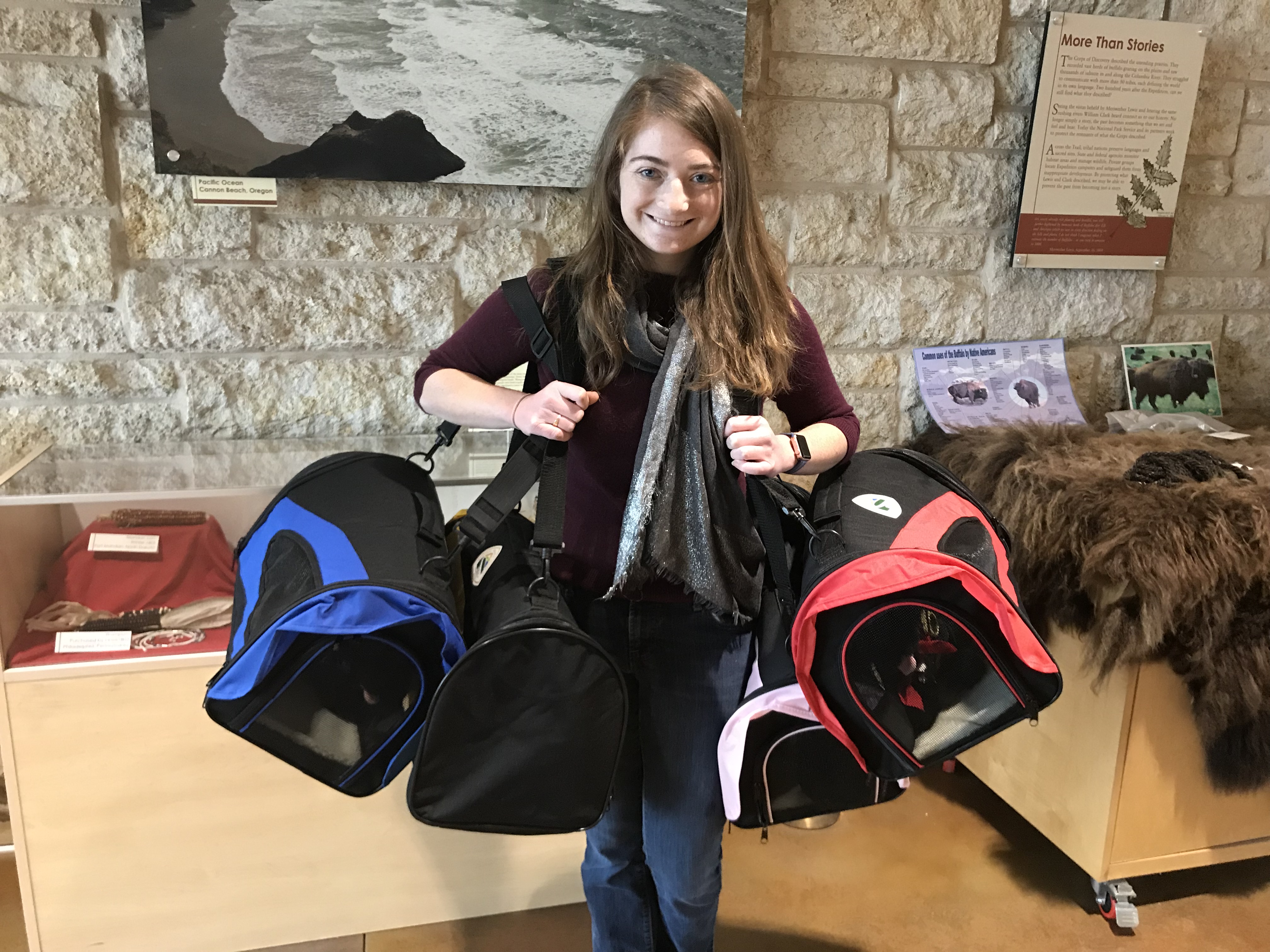 Meet Audrey Sisel Woman holding dog kennels