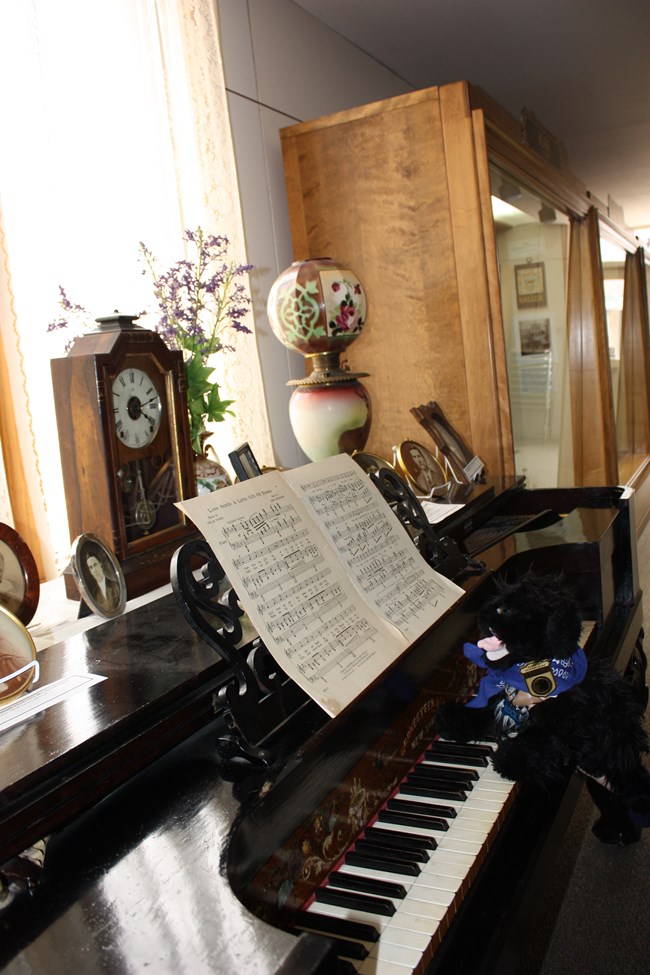 stuffed dog at old piano