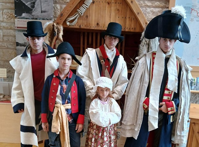 five children pose in 1800s clothing