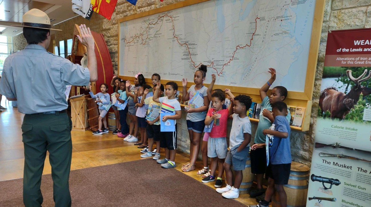 a park ranger leads a group of children