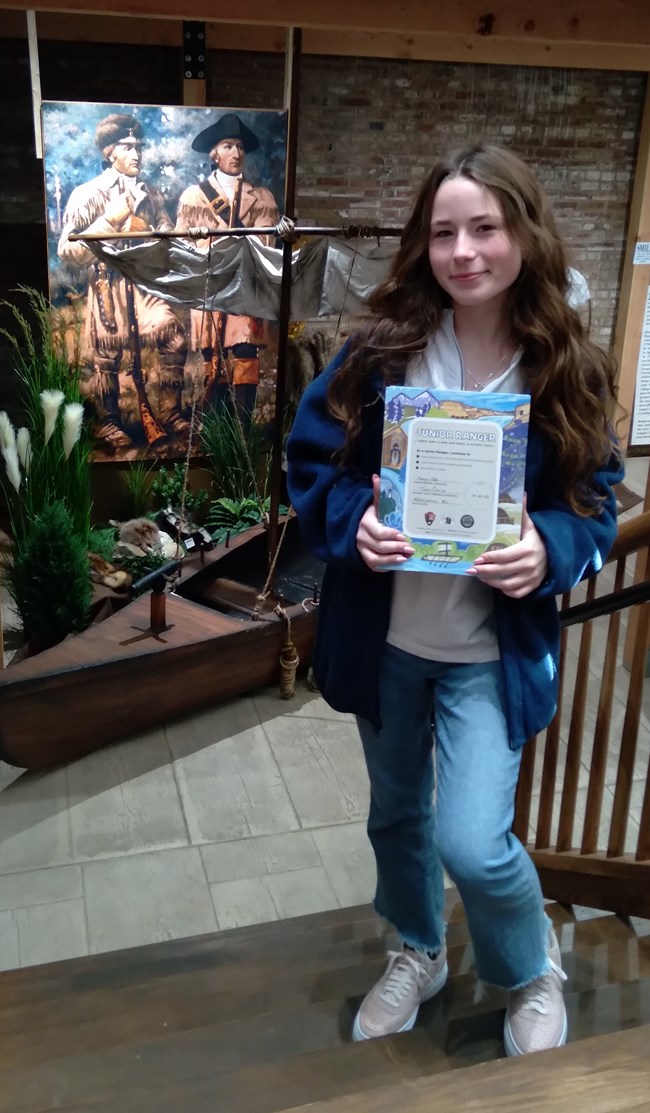 a girl holds a colorful booklet