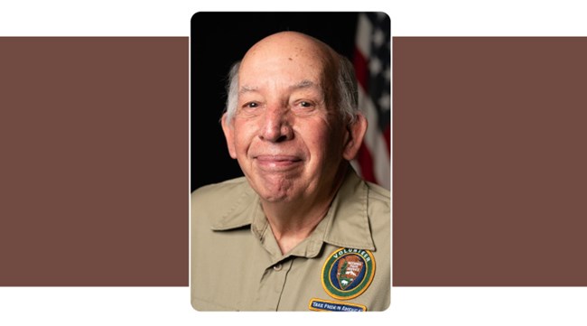 Portrait of man in tan polo with NPS Volunteer logo. White hair. American flag background.