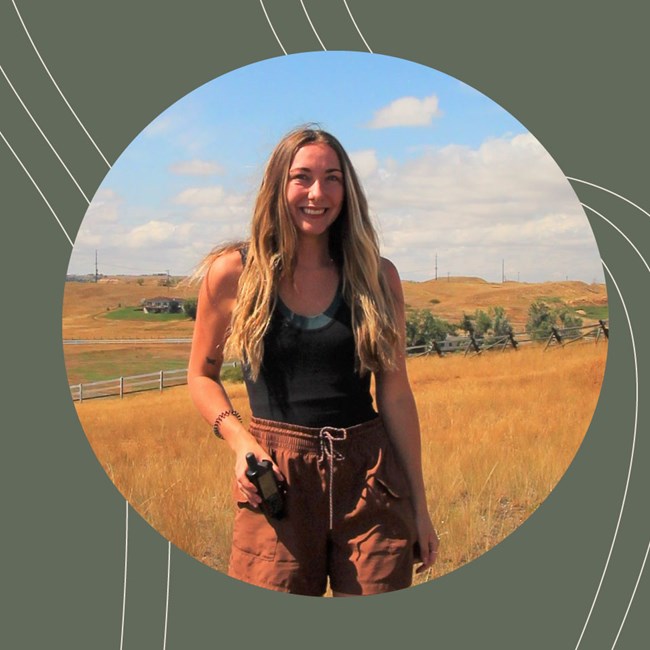 Portrait of young woman in a golden field. She has long blonde hair.