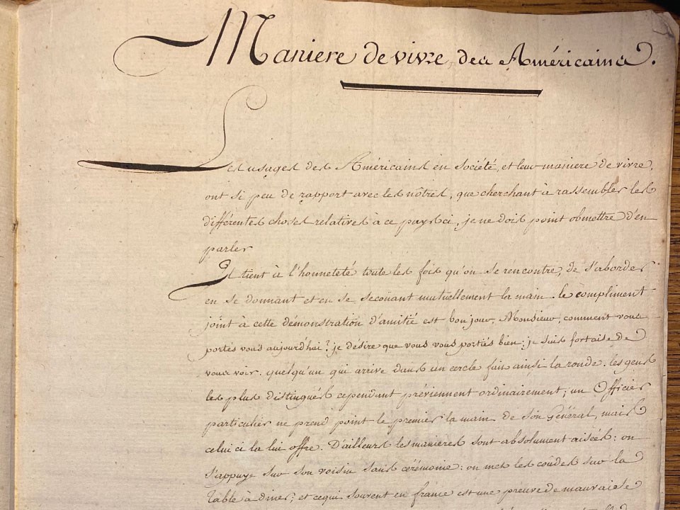 Lewis-and-Clark-and-French-Society Picture shows a faded piece of parchment with lines of cursive in French. At the top, the title reads “Manière de Vivre des Américains,” which means “The American Way of Living.”