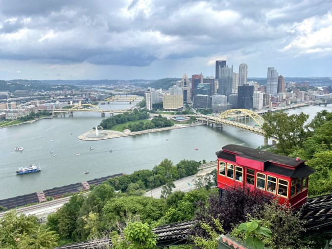 photo of Pittsburgh. Looking down on river confluence at Point State Park. Red incline car. City skyline.