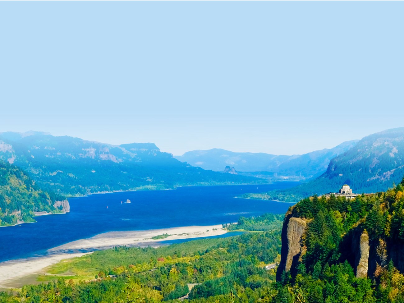 Vista house perches on a cliff in an iconic view of the Columbia River Valley in OR and WA.