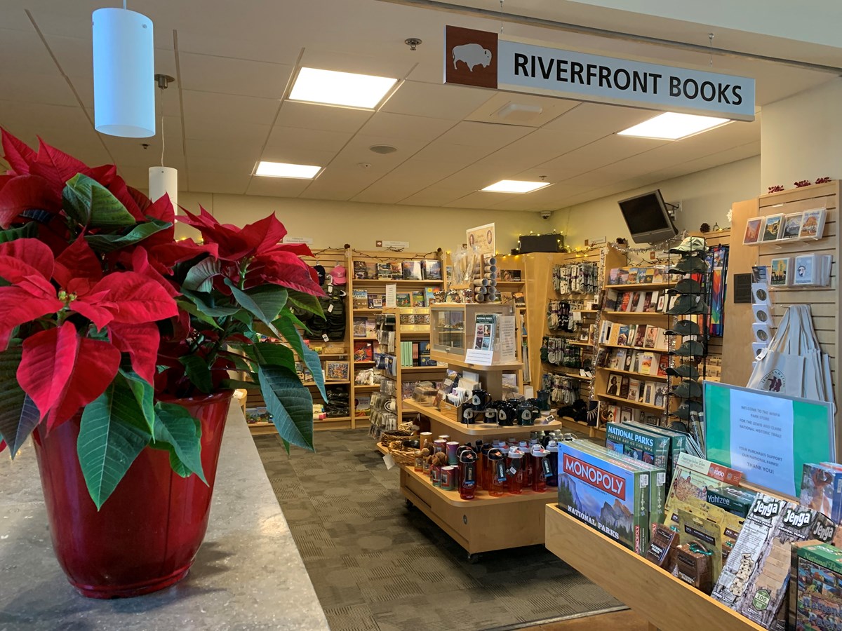 View looking into the bookstore with a red poinsettia in the foreground. View looking into the bookstore with a red poinsettia in the foreground.