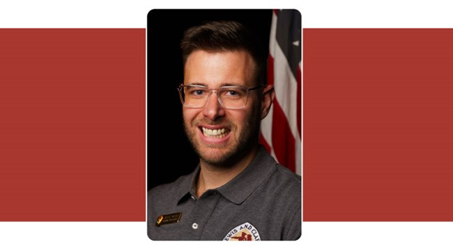 Portrait of young man with short hair and glasses in Lewis and Clark Trail polo shirt.