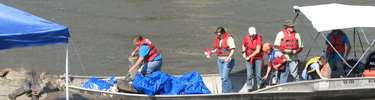 volunteers disembarking after two hours of trash pickup along the riverbanks