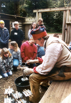 Life at the Fort Education Program ranger making candles in front of students