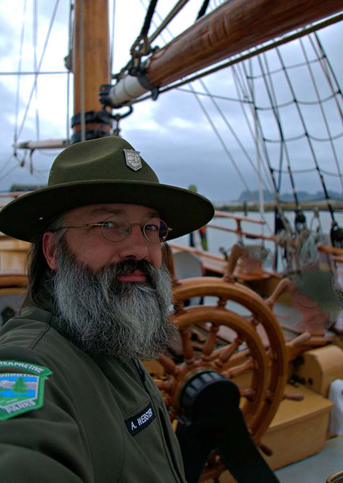 Aaron Webster A selfie of Aaron Webster taken upon a ship, the Columbia River behind it.