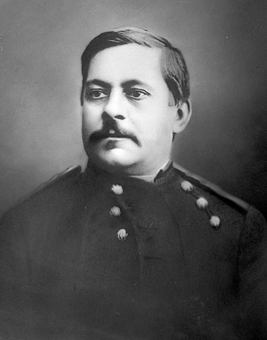 A black and white photograph of a man in a military uniform.