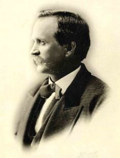 Side portrait of Charlie Reynolds wearing a bow-tie and a jacket. Side portrait of Charlie Reynolds wearing a bow-tie and a jacket.