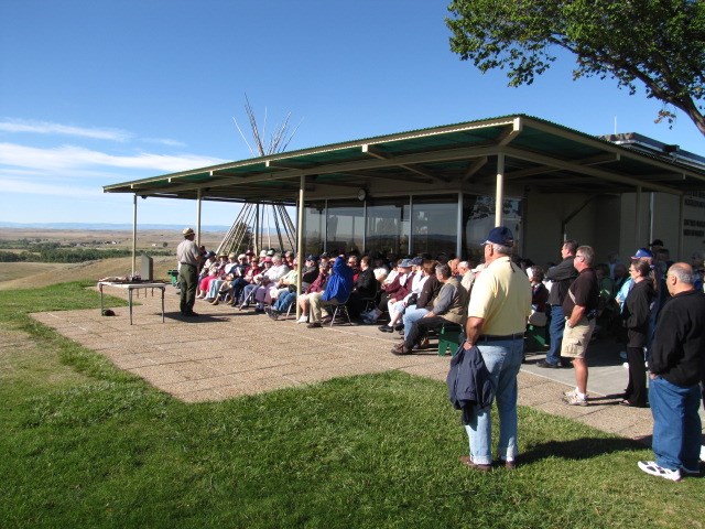 A ranger gives a talk to a group of visitors on the Visitor Center patio. A ranger gives a talk to a group of visitors on the Visitor Center patio.