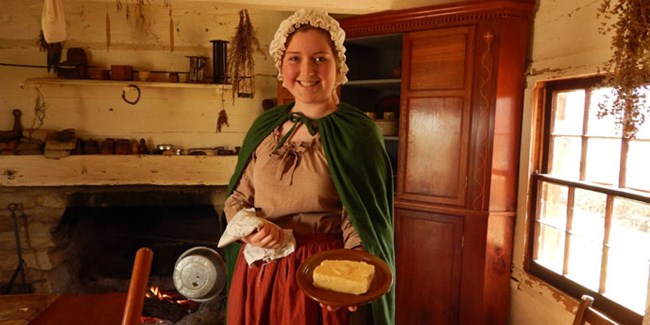 Making butter in the cabin at the Living Historical Farm Making butter in the cabin at the Living Historical Farm