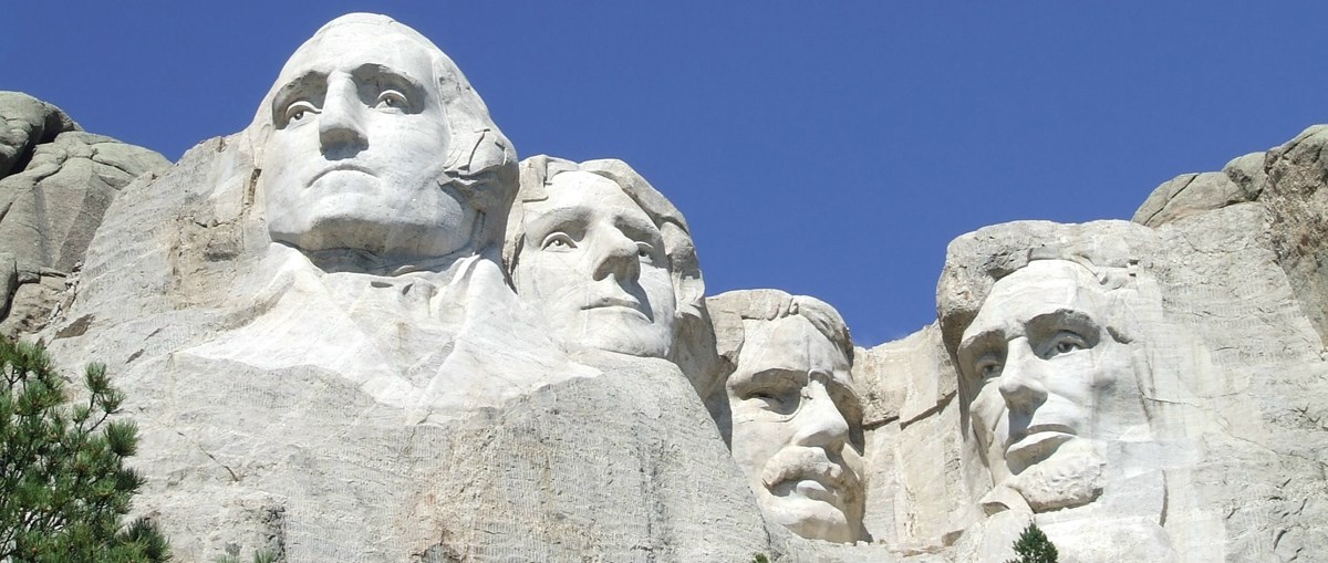 Mt. Rushmore: Giant faces of George Washington, Thomas Jefferson, Theodore Roosevelt, and Abraham Lincoln carved into a stone cliffside.