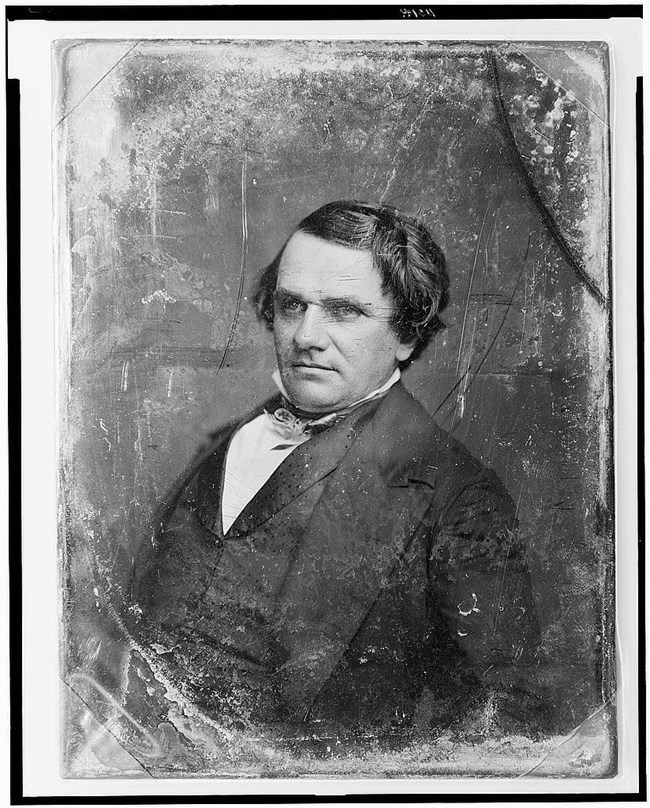 Portrait of Stephen Douglas in suit, short dark hair parted to the left. He has a slightly round face and small eyes.