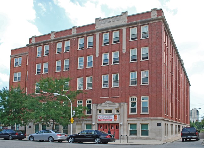 5-story red brick building with concrete foundation