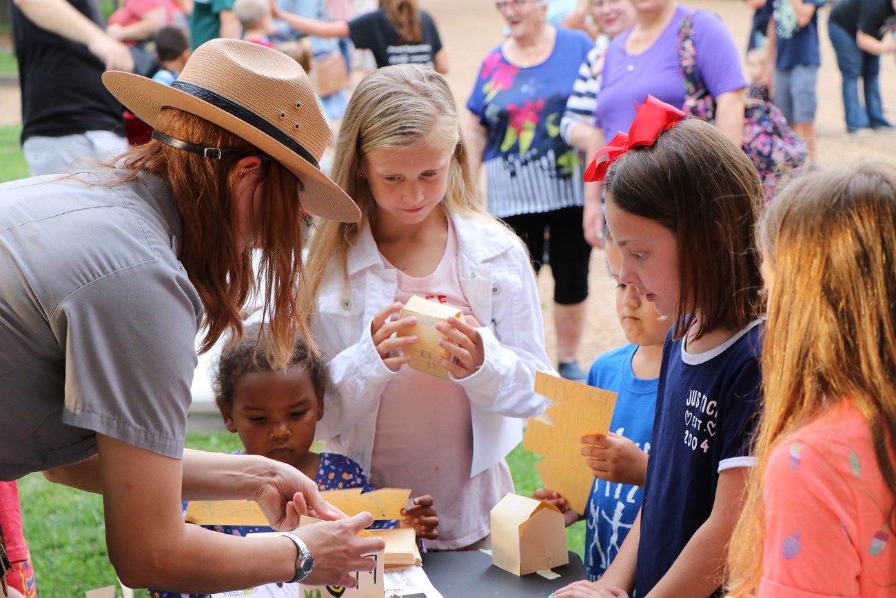 Park Ranger helps kids build a paper version of the Lincoln Home