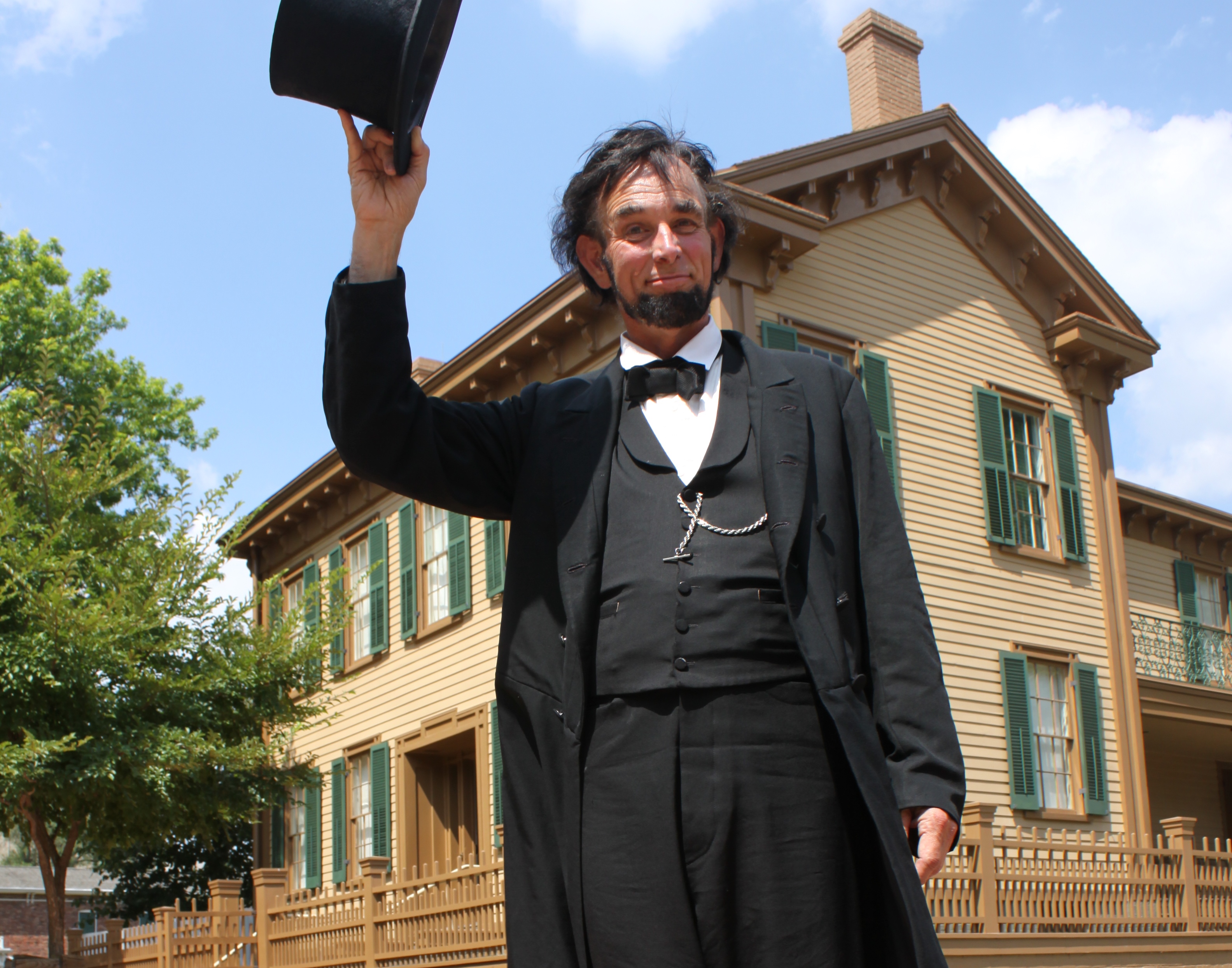 Actor portraying Abraham Lincoln in front of home