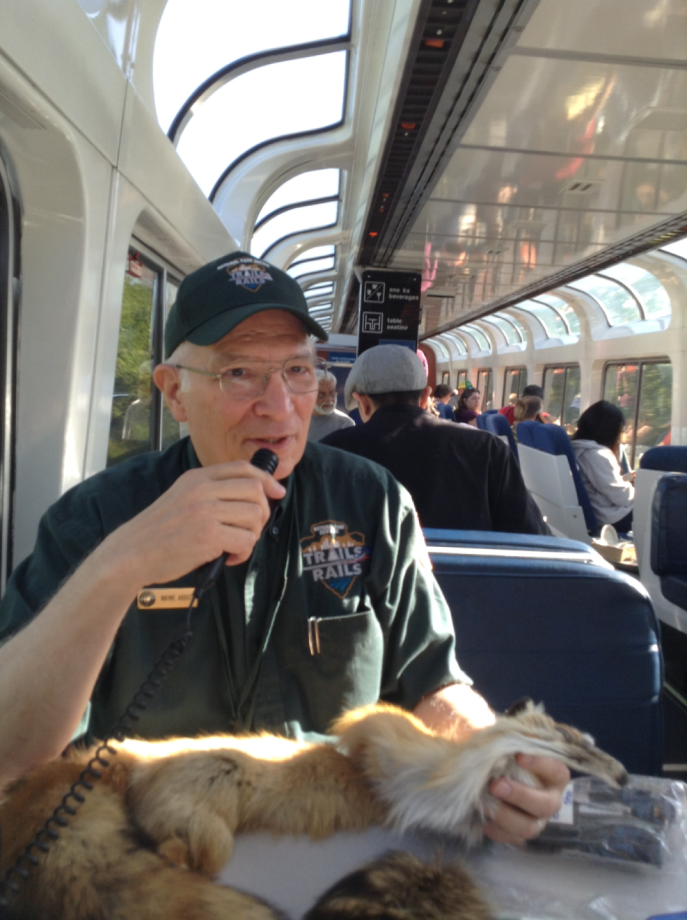 A volunteer describes an object on an Amtrak passenger car.