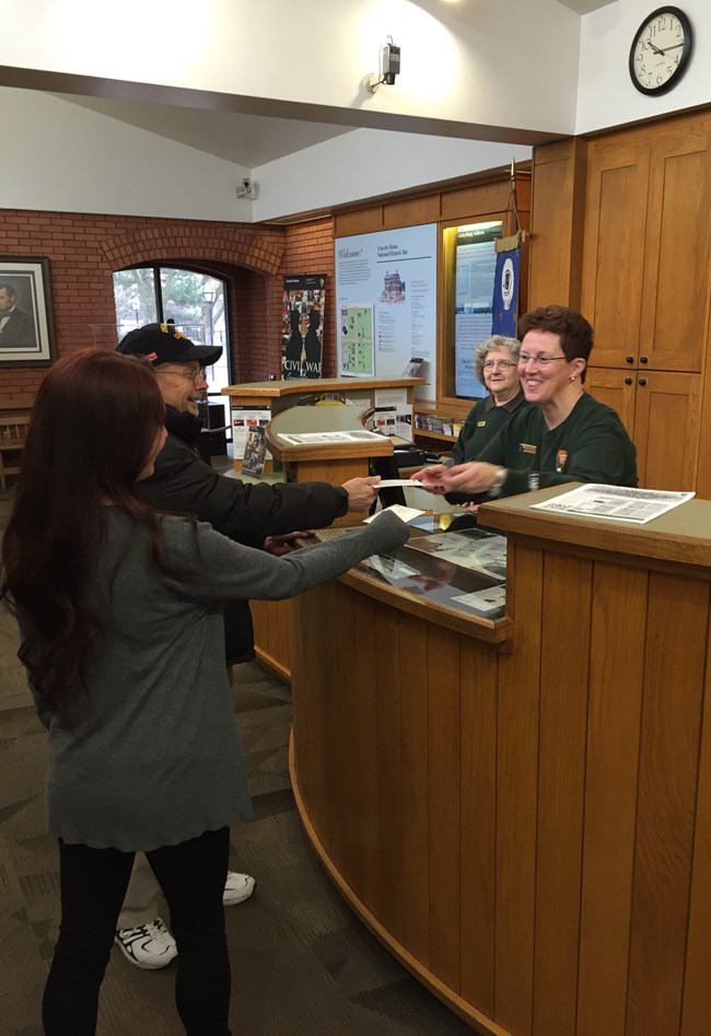 Lincoln Home volunteers give visitors info at visitor center front desk