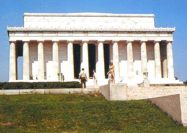A young boy and woman with the Lincoln Memorial in the background.
