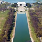 reflecting pool in center, lined with trees, and lincoln memorial at top of frame