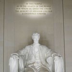 Seated lincoln with glow on text behind and above his head