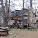 log cabin with log fence